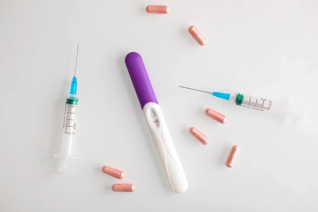Capsules and syringes on a white background representing different dosage forms of GLP-1 weight loss treatments.