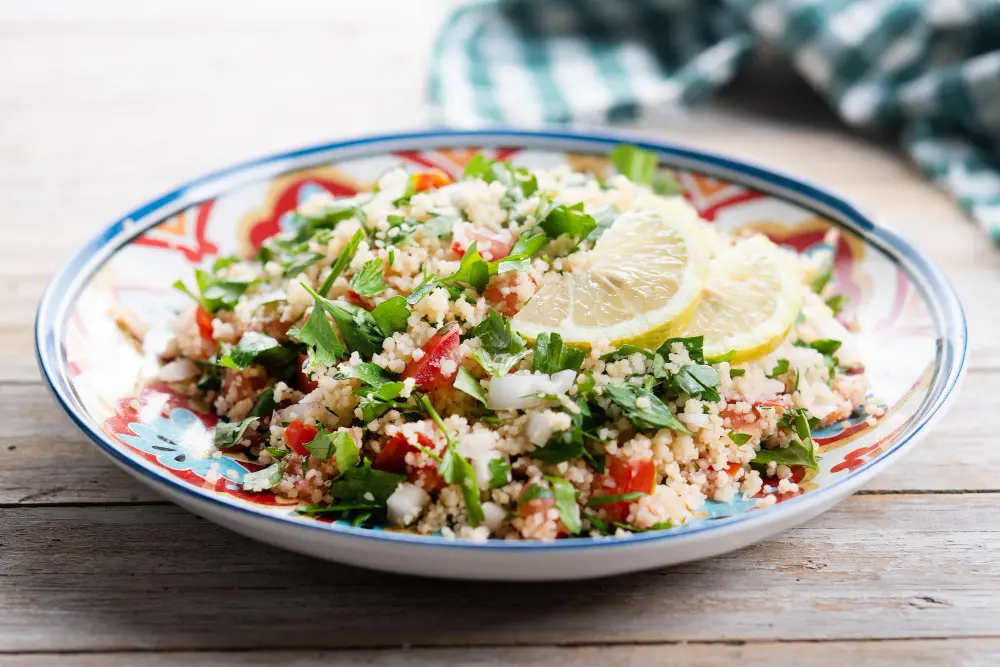 Mediterranean barley tabbouleh with chickpeas, walnuts, olive oil, tahini, parsley, rocket, tomato, and cucumber